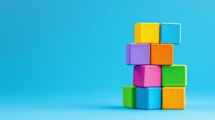 Vibrant stack of multicolored building blocks against a clean blue background, minimal design, playful energy