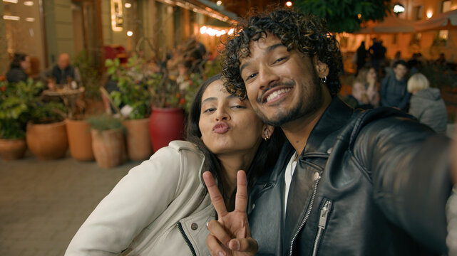 In evening night city happy Indian Arabian couple in love woman man people make selfie photo webcam web camera view travel dating posing photographing picture together relationship vacation adventure