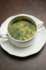 Azerbaijan dushbara soup in a white bowl. Dumplings soup with herbs