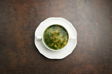 Azerbaijan dushbara soup in a white bowl. Dumplings soup with herbs