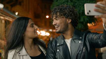 Indian Arabian couple love guy girl woman man friends boyfriend girlfriend night evening city urban talking mobile phone webcam video call record conference vlog blog smiling laughing greeting hello