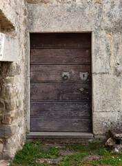 Old wooden door of stone house