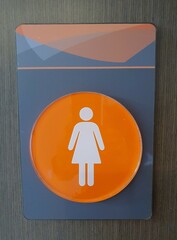 A sign indicating the way to the women's restroom.
