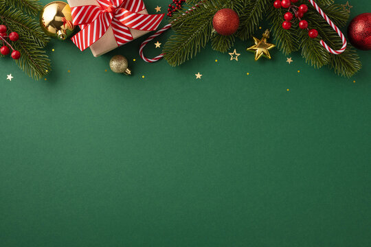 Christmas themed background featuring ornaments, a gift box with a red ribbon, and pine branches for seasonal decorations