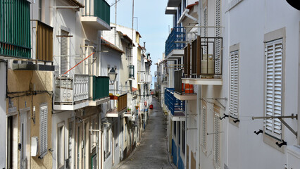 Narrow Street Stuffed with Balconies Leading to the Ocean in Nazaré, Portugal