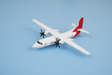 Airplane model on blue background. Travel and transportation concept.	