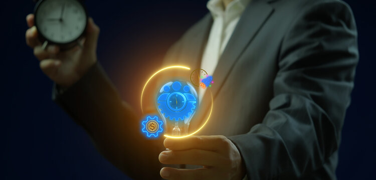 Business efficiency concept, how much a company or organization can produce as it relates to time, cost and quality. Businessman shows glowing neon line of efficiency icon on virtual screen.