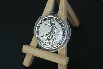 2 Pound silver coin on easel. Fine silver coin Britania 2023. Investments and numismatics.