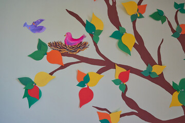 a tree made of colored paper, autumn tree with leaves made of paper on the wall
