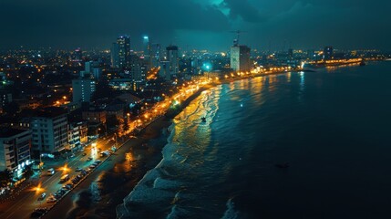 Obraz premium Nighttime Cityscape with Beach and Ocean