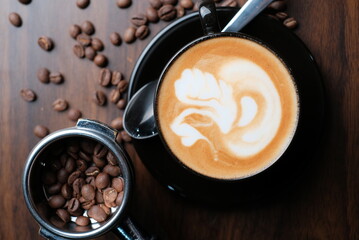 Black cups of cappuccino with latte art. Coffee bean and one cup coffee. Top view and side view. Coffee bean