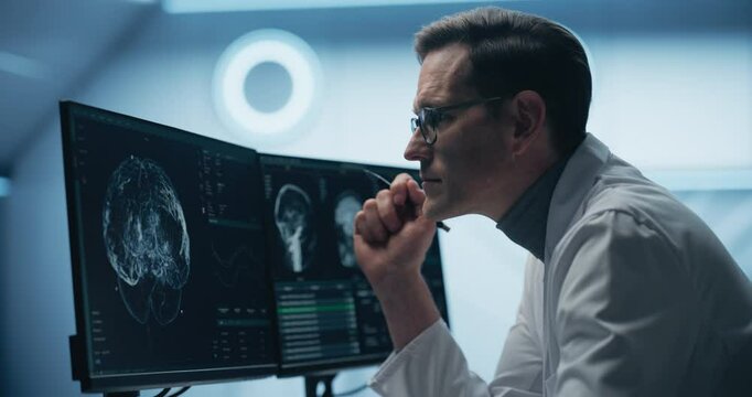 Portrait of Scientist Analyzing Brain Scans on Multiple Monitors in High-tech Laboratory. Advanced Medical Imaging Technology Displays Detailed Neurological Data for Advanced Research and Diagnosis