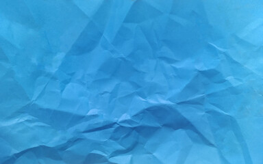 Rough crumpled texture surface of retro old vintage classic crumpled paper. Background or backdrop. Design blank. Pure or mostly pure blue