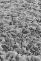 Beach, Sand, Waves. Waves breaking on the beachfront and forming incredible textures