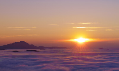 Mount Ori. Sun at sunset with sea clouds on the route of the swallows, Jeandel refuge, Pyrenees of France.