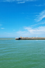 Serene Seaside with Lighthouse Under Clear Blue Sky - Coastal Recreation, Travel Concept