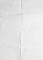 Creased recycled folded paper with dust and scratches. Grunge background texture