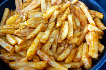 Seasoned Potato Fries in Pan Perfect for Comfort Food, Snack, or Side Dish Concepts in Culinary Photography