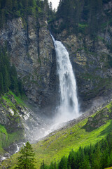 big staubifall waterfall in Switzerland alps. travel and hiking concept