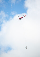 helicopter in the mountains transports logs. transport concept