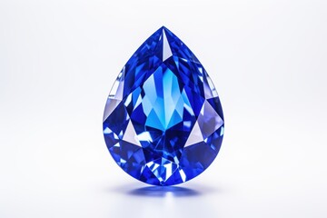 A detailed close up of a stunning blue sapphire diamond a teardrop cut placed on a white surface