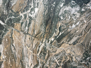 Exotic mud marble seamless background texture. Random exotic earth mud marble with black and white veinings.