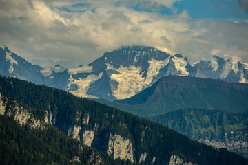 high rocky mountain ridge with snow peaks. travel and climbing concept