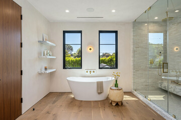 bathroom interior with bathtub and mirror, window