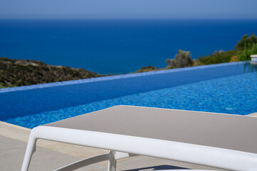 The white sun lounger was the scene's centrepiece, perfectly positioned beside the inviting pool....