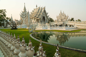 Obraz premium Chiang Rai, Thailand - March 2020: White temple or Wat Rong Khun with its resemblance in water