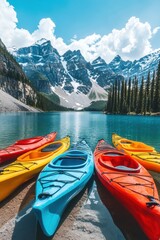 Obraz premium Kayak boat in still quiet lake water with snow mountain forest