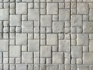 Molded texturized and patterned cement screed floor in custom square and rectangular patterns as raw concrete background texture.