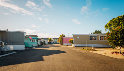 Mobile home park. A row of residential mobile park homes in a small town somewhere in California, street view. Lifestyle, architecture