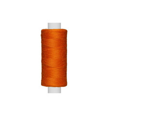 orange spool of sewing thread isolated on white background close up