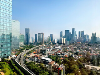 View of Jakarta downtown CBD skyline with its greeneries and residential landed houses nearby. Jakarta serves as the major port and capital city of Indonesia.