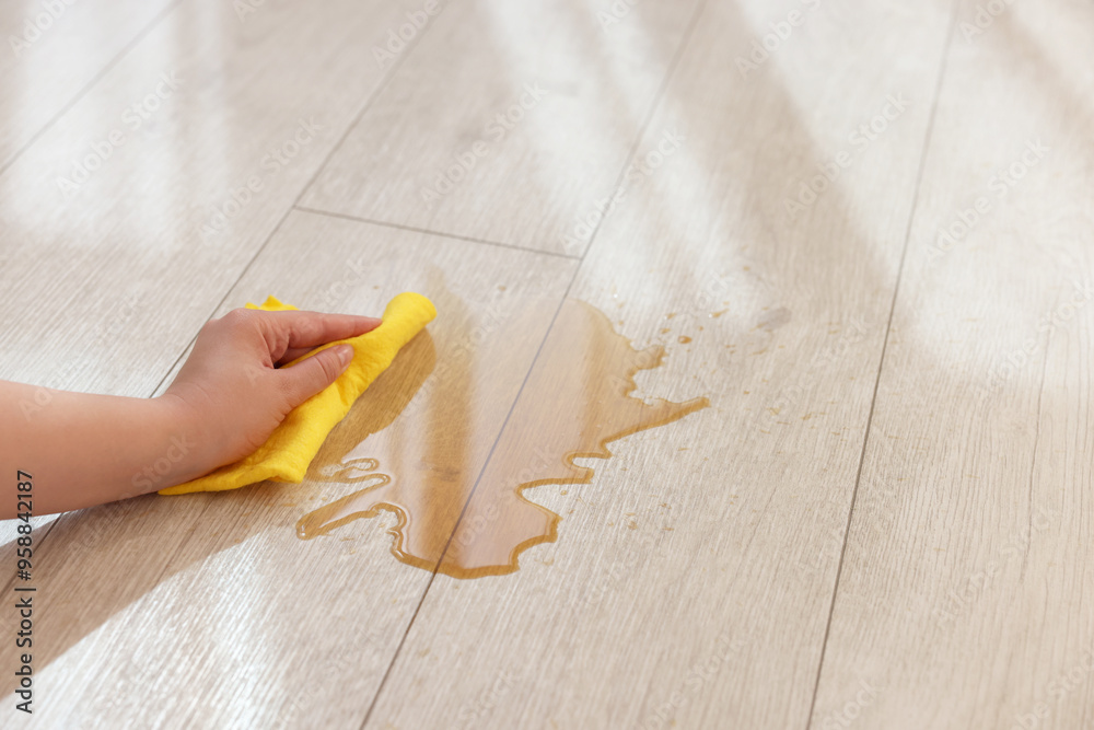 Canvas Prints Woman wiping puddle of spilled drink on floor, closeup