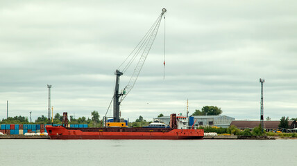 A large cargo sea vessel is at anchor, a dry cargo ship is at anchor