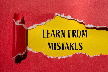 Learn from mistakes message written on ripped torn red paper with yellow background. Conceptual...