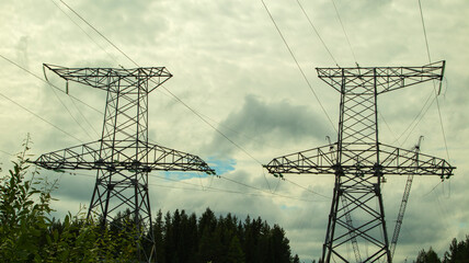 high voltage power lines against a gloomy sky