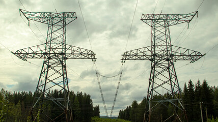 high voltage power lines against a gloomy sky