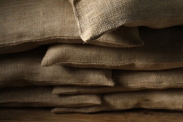 Group of burlap sacks on wooden table, closeup