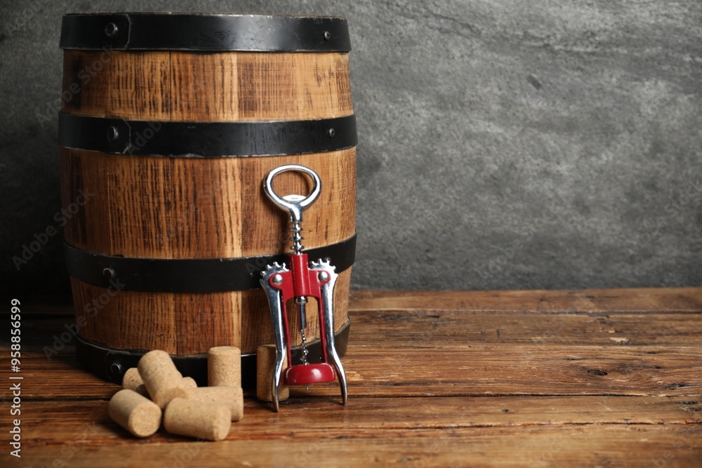 Sticker Wing corkscrew, corks and wooden barrel on table, space for text