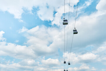 Funicular cabin or Cable car on blue sky clouds background. Sky lift. Cable transportation connects.