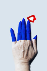 Painted blue hands touch the heart of symbol social networks. Art collage digital pop modern art.