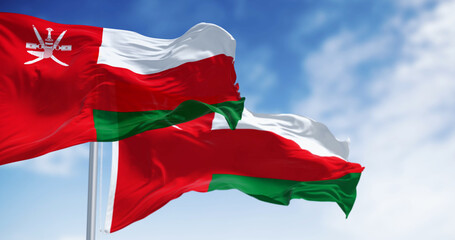 National flags of Oman waving in the wind on a clear day