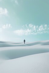 A lone figure walks across vast, snowy dunes under a clear blue sky, symbolizing solitude, adventure, and exploration. Ideal for travel, nature, and minimalist-themed visuals, evoking peace, reflect