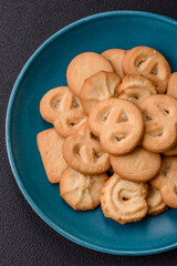 Delicious fresh sweet crispy butter cookies on a dark background