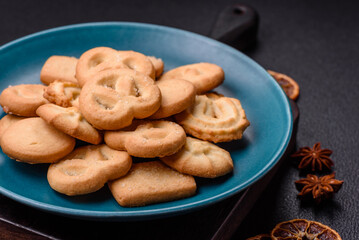 Delicious fresh sweet crispy butter cookies on a dark background