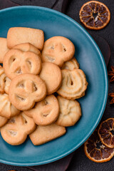 Delicious fresh sweet crispy butter cookies on a dark background