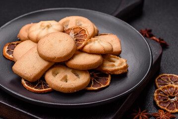 Delicious fresh sweet crispy butter cookies on a dark background